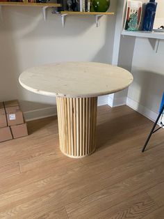 a white table sitting on top of a hard wood floor