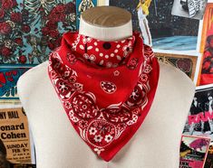 a white mannequin wearing a red bandana with black polka dots on it