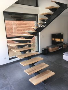 a living room filled with furniture and a stair case