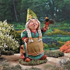 a garden gnome holding a bird in his hand