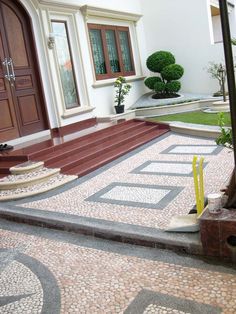 an entrance to a house with steps and potted plants