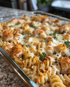 a casserole dish with chicken, cheese and broccoli in it on a counter