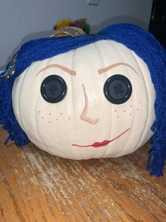 a white pumpkin with blue hair and eyes