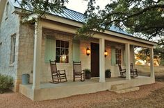 two rocking chairs on the front porch of a house