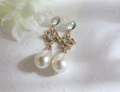 "Wedding Earrings for you Big Day!   Made of yellow gold with blue rhinestones and finished off with genuine freshwater pearls.  Classy statement earrings for so many events.  All our earrings are hypoallergenic, lead and nickel free. Made with .  For matching necklace, click here: https://www.etsy.com/listing/1299660169 ✦ Please note: All wedding jewelry and earring sales are final   ✦ Post Earrings / Blue Zircon, Gold Plated Brass; hypoallergenic, lead and nickel free ✦ Large White Freshwater Something Blue Earrings, Blue Bridal Jewelry, Blue Earrings Wedding, Blue Pearl Earrings, Blue Bridal Earrings, Bridal Traditions, Jewellery Luxury, Bridal Events, Crystal Earrings Wedding