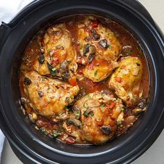 a slow cooker filled with meat and vegetables