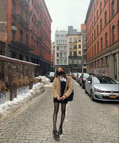 a woman standing in the middle of a street