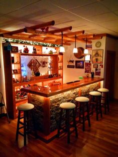 an image of a bar with stools in the middle and lights on above it