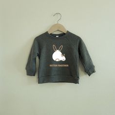 Handmade and designed kids' shirt with love by two mamas. Better Together Rabbit Sweatshirt | Cute Animal Crew Neck | Kids Sweatshirt | Toddler Animal Crew Neck FABRIC: - 7 oz., 32 singles - 52% Airlume combed and ringspun cotton, 48% polyester fleece - Pre-shrunk FEATURES: - 1X1 Ribbed Cuff And Waistband - Raglan Sleeves - Sideseamed - Heat-pressed design * Please order one size down when you purchase clothing color in pink and Olive green. CARE: - Turn garment inside out and machine wash cold Unisex Cute Tops For Loungewear, Cute Unisex Long Sleeve T-shirt, Pink And Olive Green, Sweatshirt Cute, Better Together, Kids Sweatshirt, Raglan Sleeve, Olive Green, Inside Out