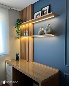 a wooden desk with two vases on top of it next to a wall mounted shelf