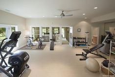 a home gym with exercise equipment and mirrors