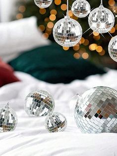 a bed topped with lots of shiny disco balls