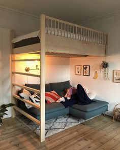 a person laying on top of a couch under a bunk bed in a living room