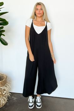 Details: Ditch the fuss and slip into this flowy, sleeveless jumpsuit. With a solid jersey design, wide cropped pants, and adjustable bra straps, this casual jumper is perfect for all-day comfort. Bonus: side pockets for all your essentials. Easy breezy, baby!- Flowy wide leg- SleevelessContent 95% Rayon Jersey 5% SpandexSize + Fit Model is 5'8" and wearing a Small - Measurements from a size Small - Full length: 53"- Inseam: 21"- Chest: 42"- Waist: 40"Brand: Emerald Collection Black Loose Overalls Outfit, Jersey Jumpsuit Outfit, Black Sleeveless Jumpsuit Outfit, Ootd Jumpsuit, Sleeveless Jumpsuit Outfit, Wide Leg Jumpsuit Outfit, Wide Cropped Pants, Jumpsuit Outfit Casual, Black Jumpsuit Outfit