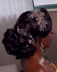 a woman in a yellow dress wearing a bridal hair piece with pearls and crystals on it