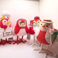 three stuffed birds are standing next to each other