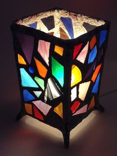 a multicolored stained glass lamp on a table