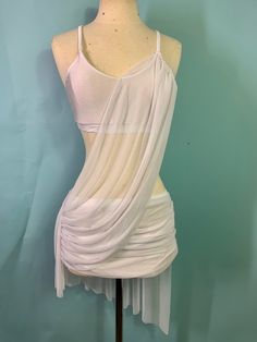 a mannequin wearing a white draped dress