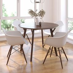 a dining room table with four chairs and a vase on top of it, in front of large windows