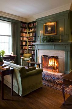 a living room filled with furniture and a fire place in front of a book shelf