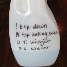 a white jug with writing on it sitting on a table