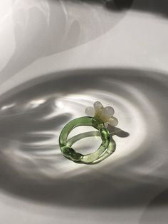 One-of-a-kind unique handmade borosilicate glass daisy flower ring in a beautiful translucent green and semi opaque white and yellow glass.  Hi, nice to digitally meet you :) My name is Maureen I am a 20-something jewellery artist with a specialisation in glass jewellery located in the Netherlands. The ring you are currently looking at is formed using a technique called lampworking. It is made from borosilicate glass also called medical-grade glass as it is the sturdiest kind of glass.  Jewel is Green Resin Flower Jewelry, Unique Green Flower Ring, Green Flower-shaped Ring For Gift, Green Flower Shaped Ring For Gift, Green Flower Ring For Gift, Green Glass Flower-shaped Jewelry, Green Flower-shaped Glass Jewelry, Green Flower Rings For Gifts, Handmade Green Flower Ring For Gift