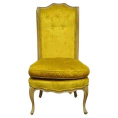 an old fashioned chair with yellow velvet upholstered on the back and seat cushion