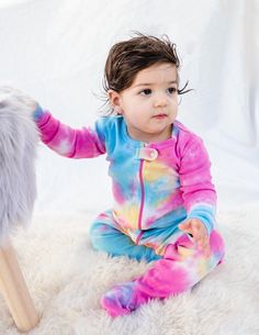 For fire safety, these pajamas should fit snugly Each product is unique due to hand dying. Please expect small differences. Tagless label to help protect baby's delicate skin Machine wash cold & inside out 100% Cotton Imported Get your little ones ready for the coziest sleep! Made from a lightweight ultra-soft cotton, our Baby Footed Pajamas are bound to be a favorite all season round. Keep their toes warm with a footed grip to follow them around on all their adventures. Comes in a variety o First Communion Shoes, Girls Gloves, Girls Dress Outfits, Footed Pajamas, Tie Dye Rainbow, Infant Flower Girl Dress, Christening Outfit, Boy Halloween Costumes, Cotton Pajamas