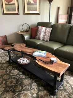 a living room with a couch, coffee table and pictures on the wall