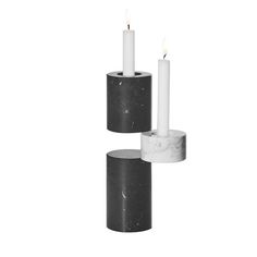 two marble candle holders with white candles in them on a white background, one is black and the other is grey