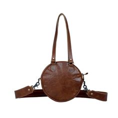 This remarkable Long Time Traveler bag is remarkably unique. It presents a classic western-style round design with hand stitched leather detail, with hair-on animal hide for the body. Brown leather backing and an adjustable strap complete the form and function. Convenient zippered opening, with roomy main compartment for all your important items while you're on the go. Item Width 10.8" Item Depth 2.5" Item Height 10.5" Shoulder 18" Handle 12.5" Note that the exact pattern of the hair-on hide and leather as pictured may vary slightly due to the crafted nature of the item. Leather Shoulder Bag With Round Handle For On-the-go, Brown Shoulder Bag With Adjustable Strap And Round Handle, Leather Bags With Adjustable Strap And Round Handle, Adjustable Leather Shoulder Bag For Everyday, Brown Bag With Round Handle And Leather Lining, Brown Round Case Bag With Detachable Strap, Everyday Shoulder Bag With Zipper And Round Handle, Everyday Shoulder Bag With Round Handle And Zipper, Leather Round Case Shoulder Bag