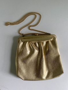 "This 1950s metallic gold vintage purse has a metal adjustable 28\" strap that can be used as a shoulder bag or doubled up and carried as tote.  It measures 8.5\" x 8.5\" and has a depth of 2\" open. Impeccable peach satin interior. Perfect vintage condition." Vintage Satchel Evening Bag For Parties, Vintage Satchel Shoulder Bag For Party, Gold Crossbody Bag For Evening, Elegant Gold Satchel Evening Bag, Gold Satchel Bag For Party, Gold Crossbody Evening Bag, Gold Crossbody Shoulder Bag For Party, Gold Shoulder Evening Bag, Vintage Clutch Shoulder Bag For Party