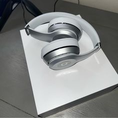 a pair of headphones sitting on top of a white box