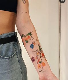 a woman's arm with flowers on it