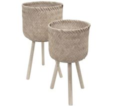 two baskets sitting on top of wooden legs