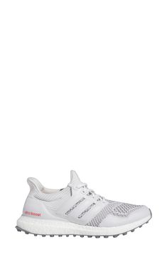 the adidas ultraboost running shoe is white and has red detailing on the upper part