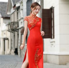 This elegant red qipao, also known as a cheongsam, is a stunning example of traditional Chinese fashion with a contemporary twist. The dress features a vibrant red and golden hue, symbolizing luck and prosperity, making it an ideal choice for special occasions such as weddings, festivals, or formal events. Size Guide: Please refer to the size guide picture before placing the order. Please leave your Height, Weight and Bust/Waist/Hip measurements in the Personalisation box so we could double chec Formal Long Red Cheongsam, Elegant Red Summer Cheongsam, Elegant Red Sleeveless Cheongsam, Elegant Sleeveless Red Cheongsam, Red Traditional Cheongsam For Evening, Traditional Red Cheongsam For Evening, Red Short Sleeve Cheongsam For Party, Red Fitted Summer Cheongsam, Elegant Red Ao Dai For Festive Occasion