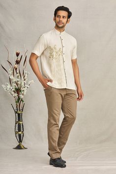 Beige linen shirt with animal embroidered motifs and mandarin collar.
Component: 1
Pattern: Embroidered
Type Of Work: Animal
Neckline: Mandarin
Sleeve Type: Short Sleeves
Fabric: Linen
Color: Beige
Other Details: 
Folk art embroidery
Closure: Front buttons
Note: Pant worn by the model is not for sale
Occasion: Resort - Aza Fashions Beige Linen Shirt, Men Shirts Casual, Folk Art Embroidery, Embroidered Motifs, Art Embroidery, Linen Color, Manish, Animal Shirts, Embroidered Shirt