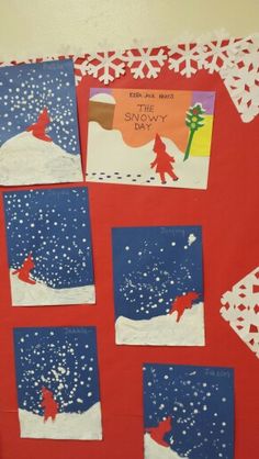 a red bulletin board with snowflakes on it and pictures cut out to look like santa's sleigh