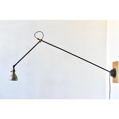 a wall light with a long arm and two lights attached to the back of it