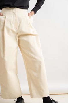 High waisted, voluminous pant with deep front pleats in a peached cotton twill. Details include one deep pleat at front, two side pockets and two single jet pockets at back. 100% Cotton Made in Portugal Wash at 30°C / Dry Clean Chic Cotton Chinos With Tapered Leg, Chic Pleated Cotton Wide Leg Pants, Chic Cotton Pleated Wide Leg Pants, Chic Cotton Chinos Trousers, Chic Cotton Ankle-length Chinos, Cream Wide Leg Bottoms With Belt Loops, Chic Cotton Chinos, Pleated Ankle-length Cotton Bottoms, Cotton High-waisted Wide Leg Pants With Welt Pockets