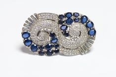 Extremely Rare 1940’s TRIFARI by Alfred Philippe rhodium plated blue crystal double clip brooch in very good condition. The Parisian born Alfred Philippe trained at the prestigious design school ‘L’Ecole Boulle.’ After emigrating to the US he worked as a fine jewellery designer for William Scheer Inc., one of the foremost manufacturing jewelers of the Art Deco era. Scheer created items for Cartier & Van Cleef & Arpels and Philippe was responsible for several full collections for these prestigious houses. Following the Crash in 1929, Philippe moved to Trifari as a designer, eventually becoming the head designer where he worked until his retirement in 1968. His fine jewelry experience strongly influenced his designs and jewelry manufacturing techniques. Collectors item! Approximate Measureme Vintage Blue Diamond Brooch, Vintage Blue Diamond Brooches, Blue Art Deco Formal Brooch, Trifari Brooch, 1960s Jewelry, Trifari Jewelry, Design School, Pin Pendant, Fine Jewelry Designers