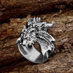 Cool massive ring with a Dragon, made of sterling silver - will adorn you or your loved one! Men's silver ring is a great gift for the New Year and Christmas, father of the bride gift! The dragon is a symbol of the coming new year. Perfect for those born in the Year of the Dragon. The strength of the dragon is not just brute strength, it is combined with wisdom. The dragon is often portrayed as the keeper of hidden knowledge. This ring represents the concept of intelligence and insight, a powerful tool wielded by those who seek to carve their way through the thick of uncertainty. We invite you to the store of exclusive jewelry handmade in the styles of gothic, steampunk, skull, viking, slavic, norse, amulets, scandinavian, masonic, muslim, engagement, wedding. Personalization possible Mate Dragon Design Ring Jewelry Gift, Dragon Design Ring Jewelry For Gift, Symbolic Skull Ring Gift, Symbolic Skull Ring With Open Design, Symbolic Skull Ring Gift Open Ring, White Gold Polished Skull Ring Gift, Symbolic Skull Open Ring As Gift, White Gold Skull Ring With Polished Finish Gift, White Gold Skull Ring With Polished Finish