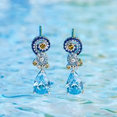 Sparkling and stunning, these earrings will capture your heart at first sight. A combination of light blue, midnight blue, yellow gold and white stones, each eye-catching earring features a premium miniature version of Van Gogh's timeless Starry Night painting and a pear cut stone. This piece of work reminds us to trust our dreams and not believe the critics of the world. "There is always hope, even in the darkest of times." So trust your dream and let this alluring jewelry make a statement.Cara Blue Diamond Earrings With Sparkling Stones, Blue Diamond Drop Earrings, Blue Diamond Pierced Earrings, Exquisite Blue Earrings, Luxury Blue Topaz Blue Earrings, Blue Luxury Earrings With Gemstone Accents, Luxury Blue Pierced Earrings, Exquisite Blue Gemstone Earrings, Blue Gemstone Drop Earrings