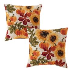 two decorative pillows with sunflowers and pumpkins on them, both in orange