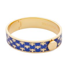 a blue and gold bracelet with flowers on it