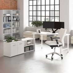 an office with white furniture and brick walls