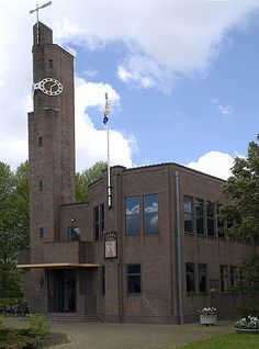 an old brick building with a clock tower in the middle of it's front