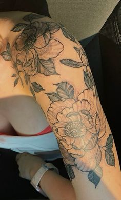 a woman's arm with flowers on it