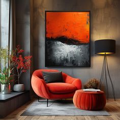 an orange chair and ottoman in a living room with a painting on the wall behind it